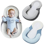 Baby laying in anti rollover pillow with various colors on white background
