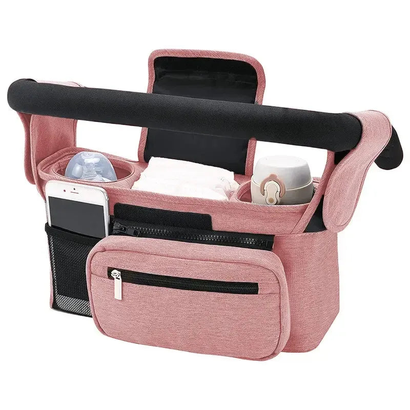 Pink stroller organizer with cup holders and phone pocket on a white background