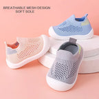 Three pairs of toddler shoes in blue, gray, and pink on a pink background with text indicating 'Breathable mesh' and 'Soft bottom'.