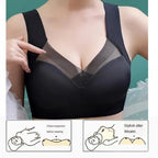 Black high support sport bra with mesh panels worn by a person, on a teal background