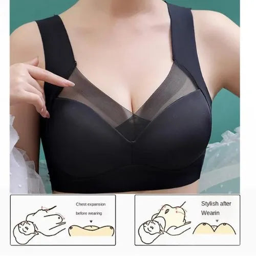 Black high support sport bra with mesh panels worn by a person, on a teal background