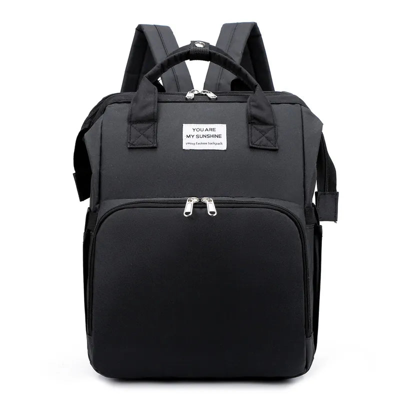 Black multifunction portable diaper backpack with white accents on a white background