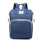Blue multifunction portable diaper backpack with white accents on a white background