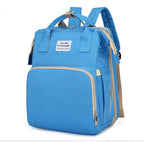 Light blue multifunction portable diaper backpack with white accents on a white background