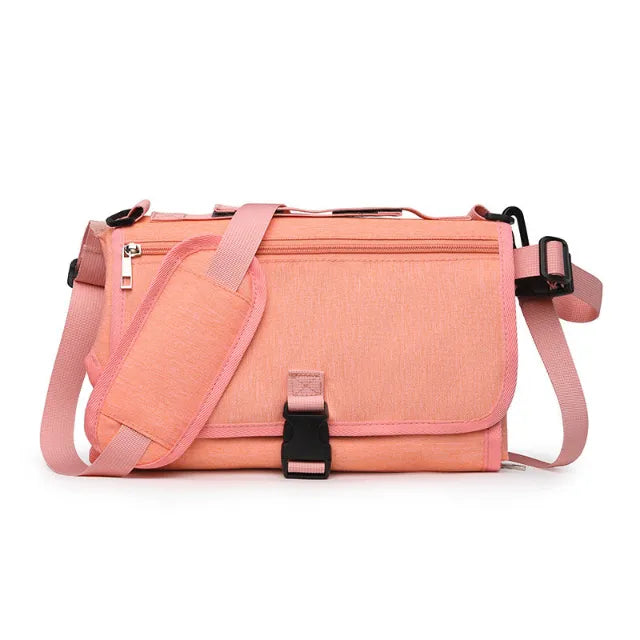 Pink portable changing pad on white background