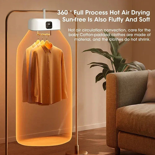 Hanging portable dryer showing hot air drying with clothes inside, placed in a room with a sofa and plant.