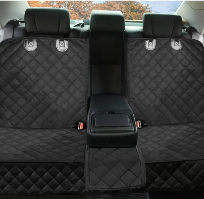 Black quilted car seat cover with a central storage compartment in a vehicle.