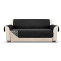 Black quilted waterproof sofa cover on a beige sofa with white background